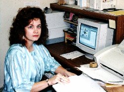 Carrie Cook at computer preparing a manuscript.