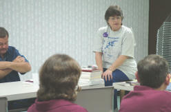 Fredrea Cook speaks to the Muskogee Genealogical Society about fund raising - notice fund rasier t-shirt attire.